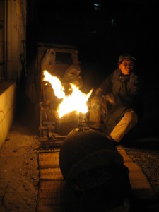 A FLAME in the night, making puffed rice and pop-corn the old-fashion way! That fire HAS to be illegal!